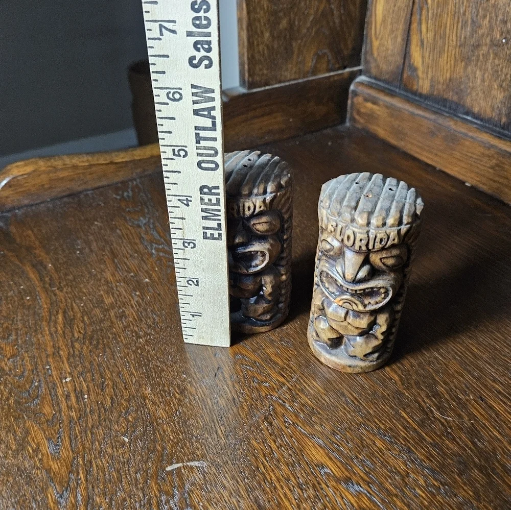 Set of vintage Florida ceramic tiki salt and pepper shakers.